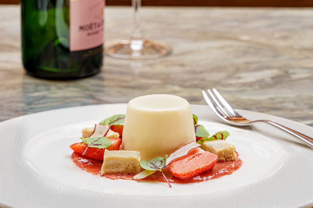 Panacotta pudding served with pieces of strawberries and shortbread