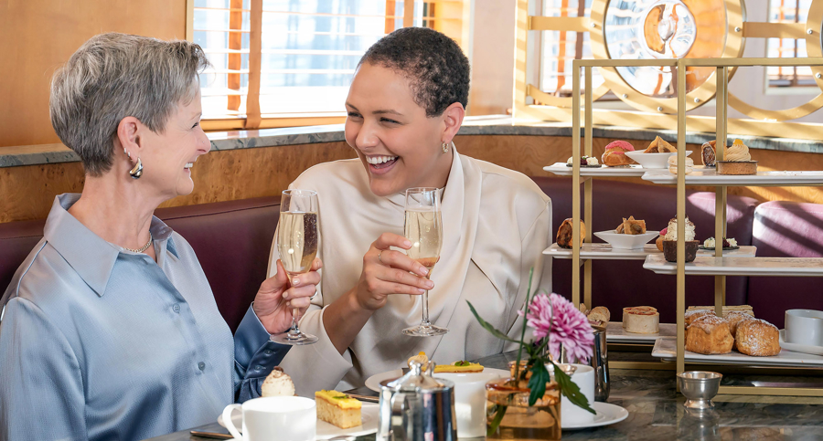 Mother and daughter have a glass of Champagne while enjoying Afternoon Tea