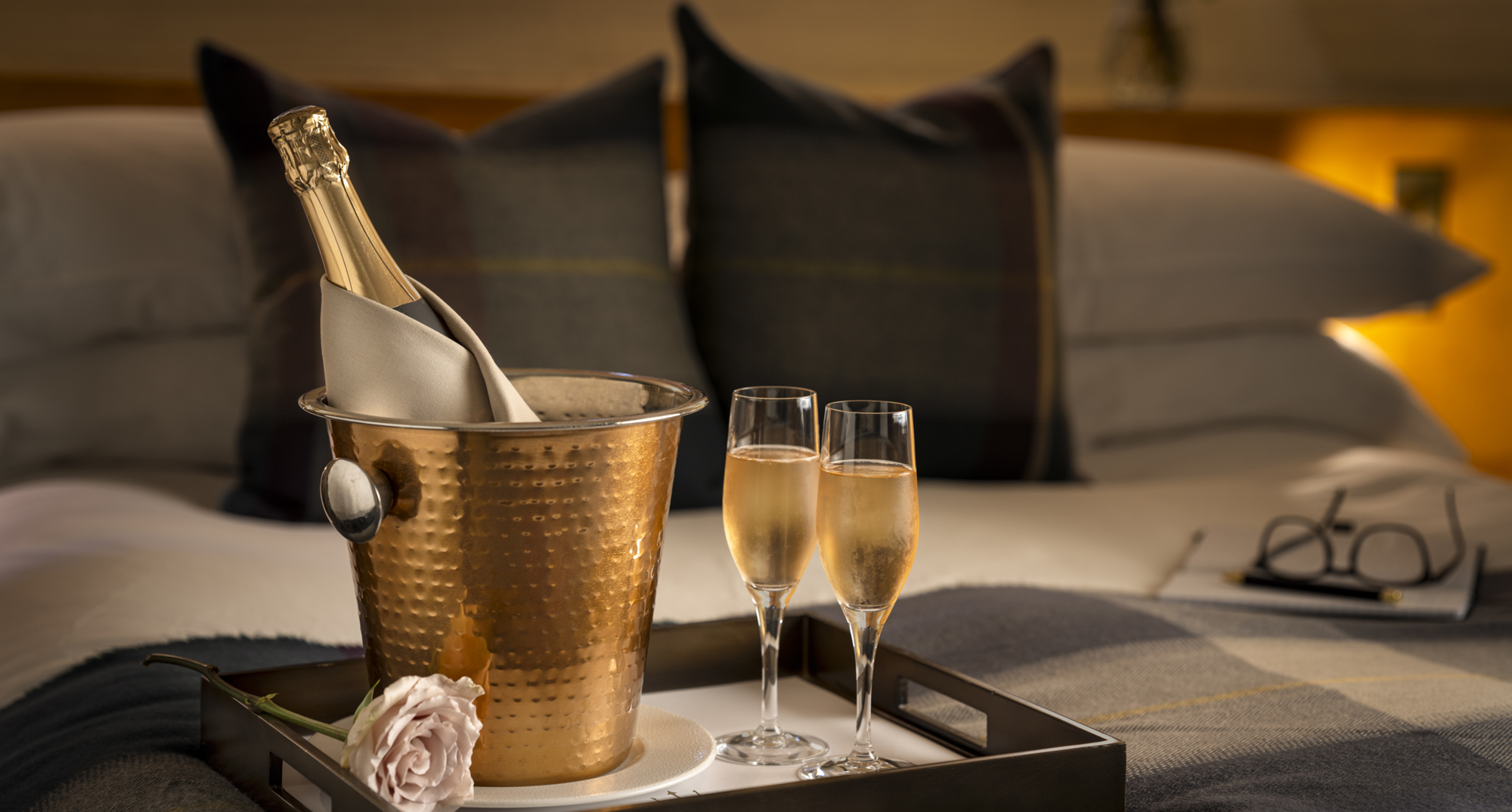 Rose and bottle of champagne in a brass cooler with two flutes during two night Edinburgh stay at luxury hotel