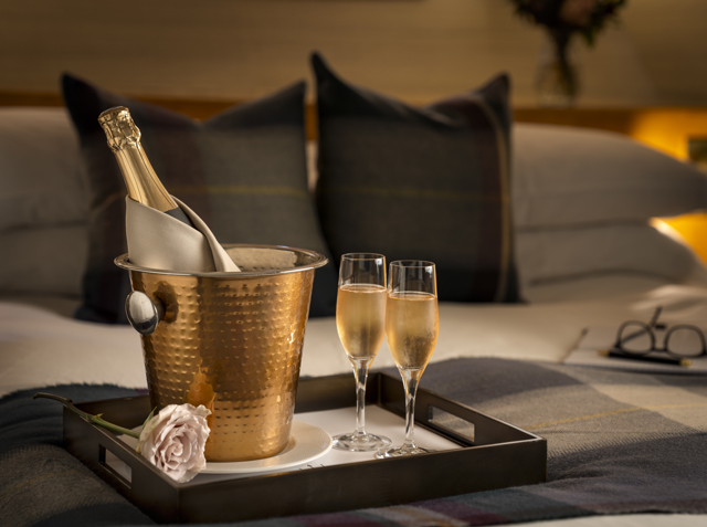 Rose and bottle of champagne in a brass cooler with two flutes during two night Edinburgh stay at luxury hotel