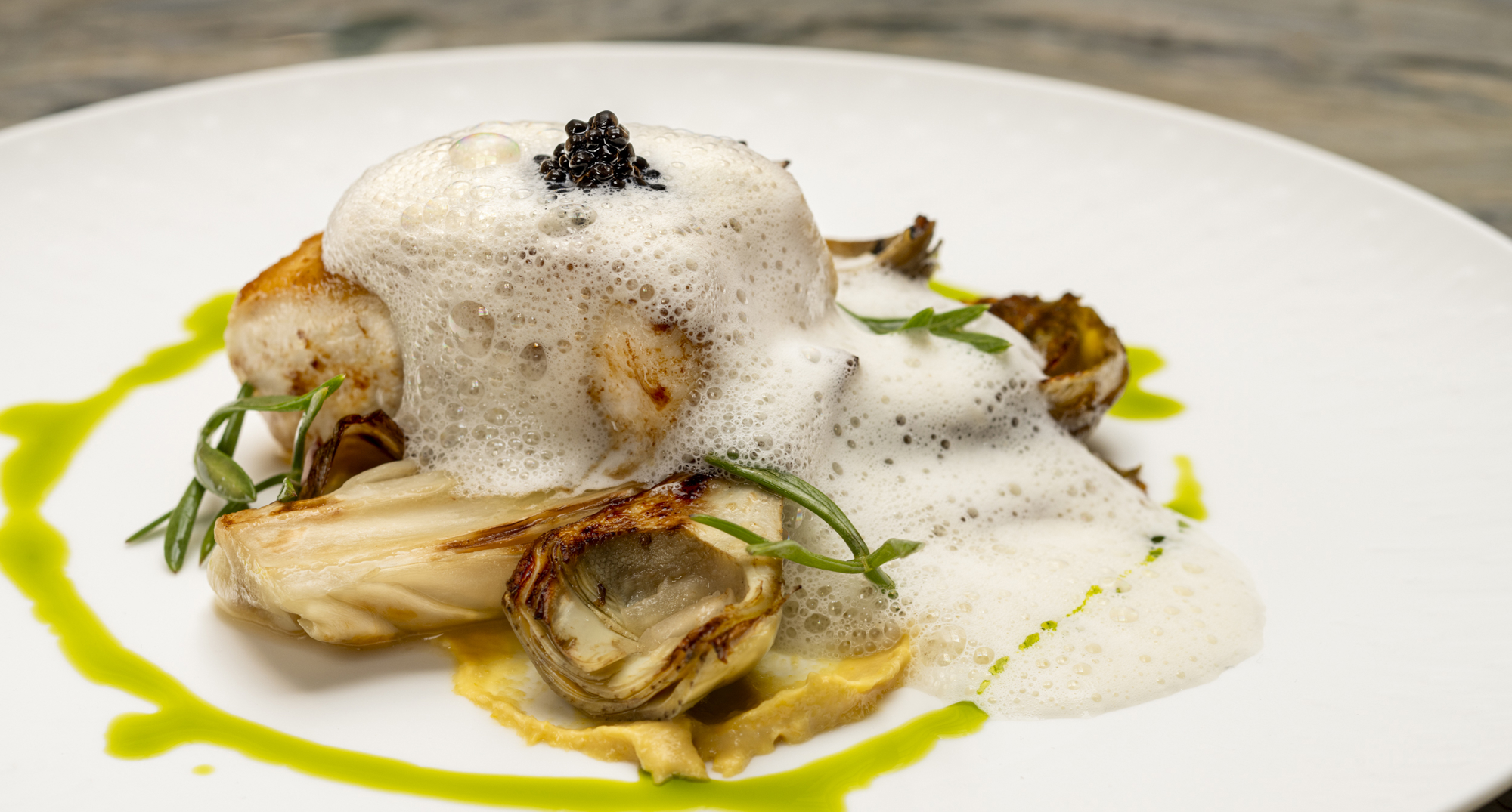 Peterhead hake, chicory, artichoke barigoule, sweetcorn, smoked Champagne velouté, caviar. 