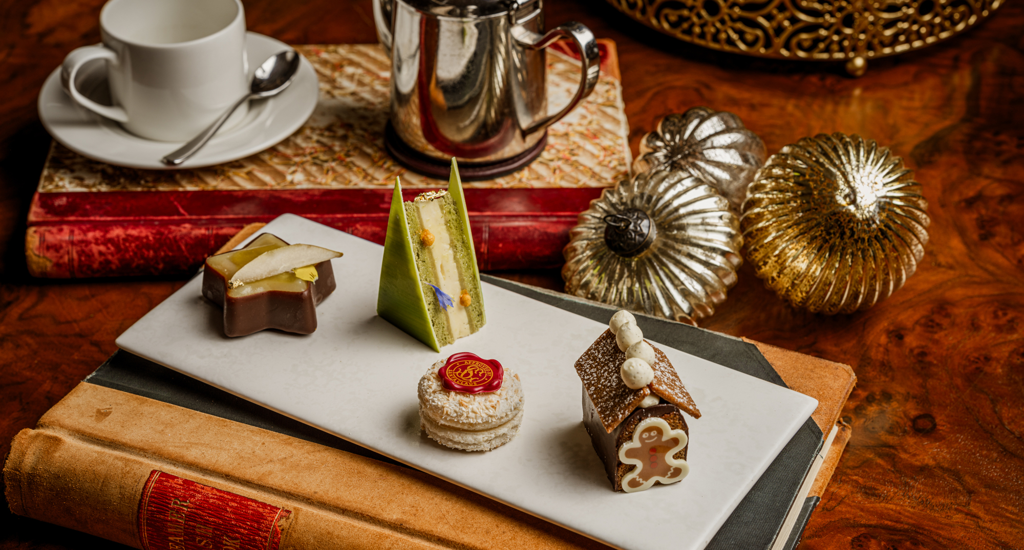 Festive afternoon tea selection aboard Fingal in Edinburgh at Christmas, featuring seasonal pastries and elegant miniature desserts