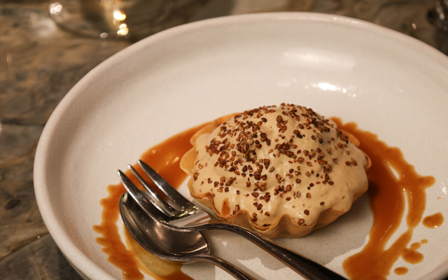 Dessert on a plate with syrup nicely poured around it. 